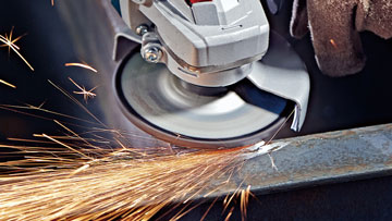 A Bosch Professional cutting machine cuts metal, sparks fly.