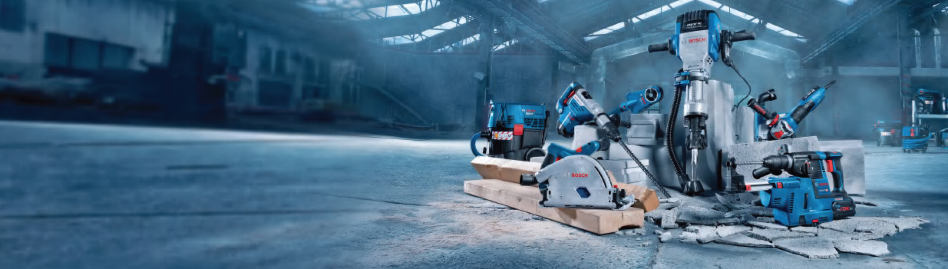 Bosch Professional tools on concrete floor, various machines and accessories.