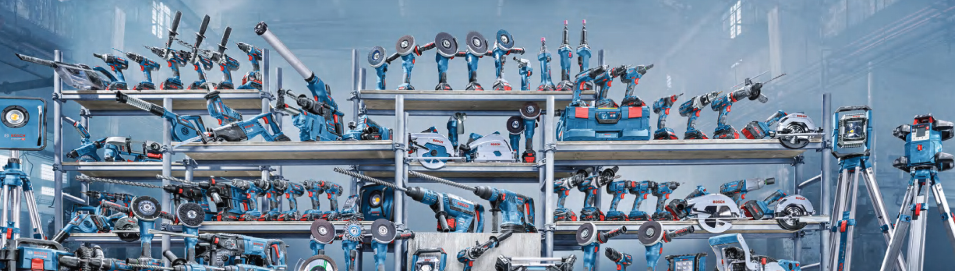 Various blue Bosch Professional tools on shelves in a hall.
