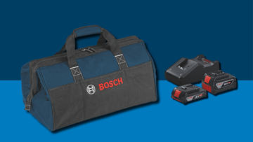 A blue tool bag from Bosch with a red logo lies on a blue background, next to two batteries and a charger.