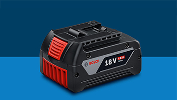 A black Bosch Professional 18V battery is lying on a blue background. The battery has red and gray accents.