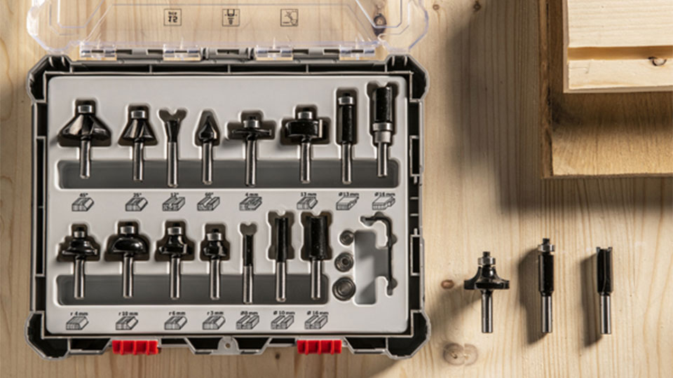 Black Bosch Professional milling tools in a case on a wooden surface.